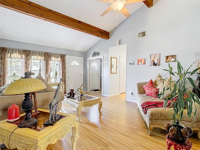 living room featuring ceiling fan, hardwood / wood-style flooring, and lofted ceiling with beams