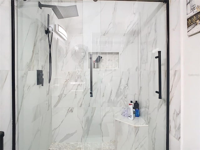 bathroom with a tile shower