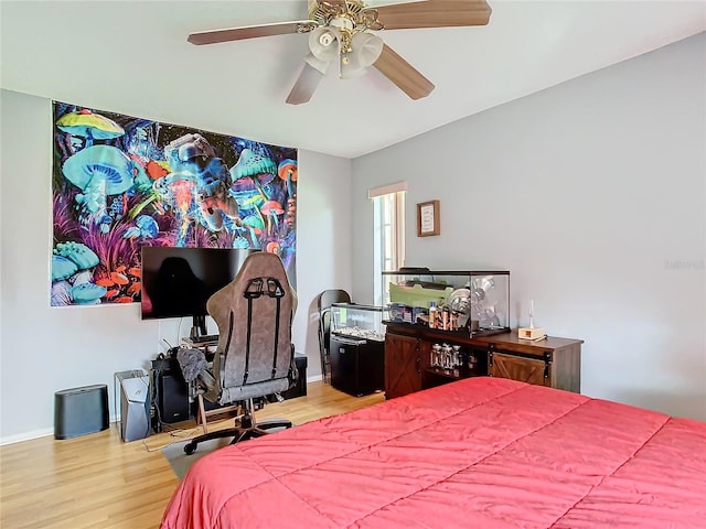 bedroom with ceiling fan and hardwood / wood-style flooring