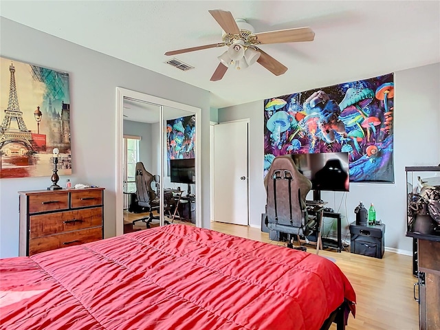 bedroom with ceiling fan, a closet, and hardwood / wood-style floors