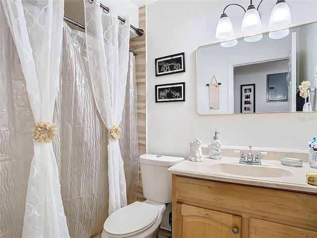 bathroom with toilet, vanity, and a shower with shower curtain