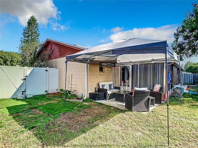 rear view of house featuring a yard and an outdoor living space