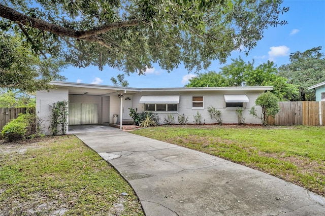 ranch-style house with a carport and a front lawn