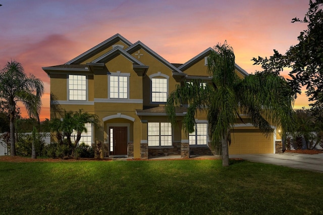 view of front facade featuring a lawn and a garage