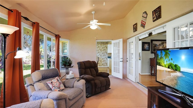 living area with lofted ceiling, french doors, and a ceiling fan