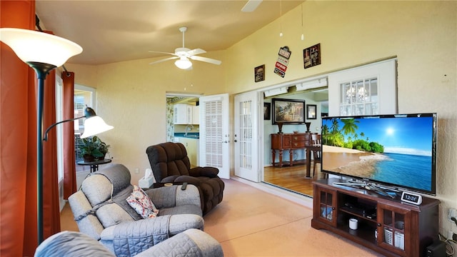 living area with a ceiling fan, lofted ceiling, and french doors