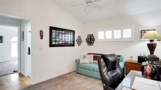 office space featuring carpet floors, vaulted ceiling, baseboards, and ceiling fan