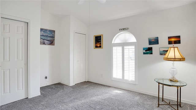 interior space featuring carpet, ceiling fan, and baseboards