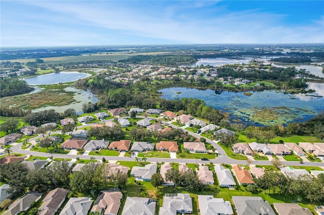 drone / aerial view featuring a residential view and a water view