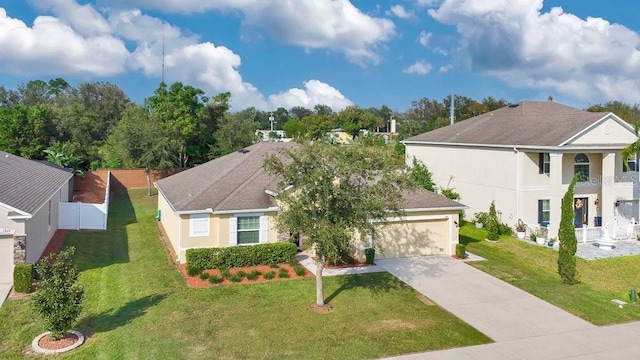 view of front of property featuring a balcony, a front yard, and a garage