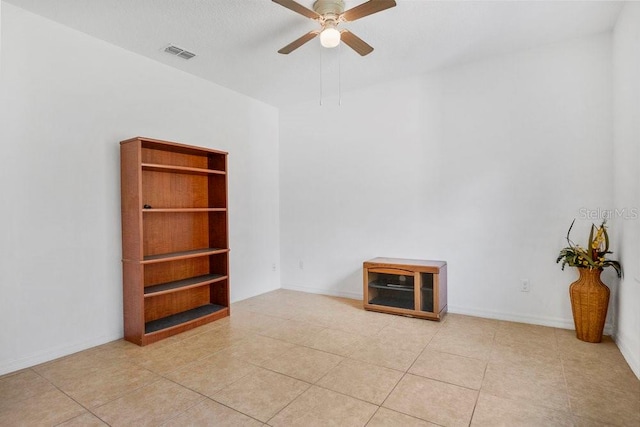 empty room with light tile patterned flooring and ceiling fan