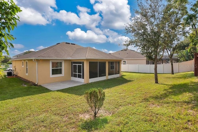 back of property featuring a patio area, a yard, and a sunroom