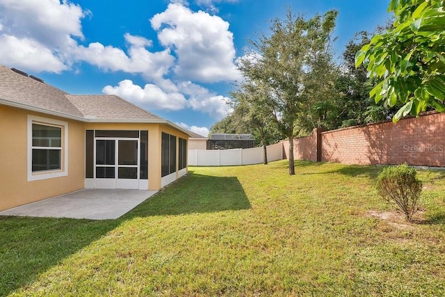 view of yard featuring a patio and a sunroom