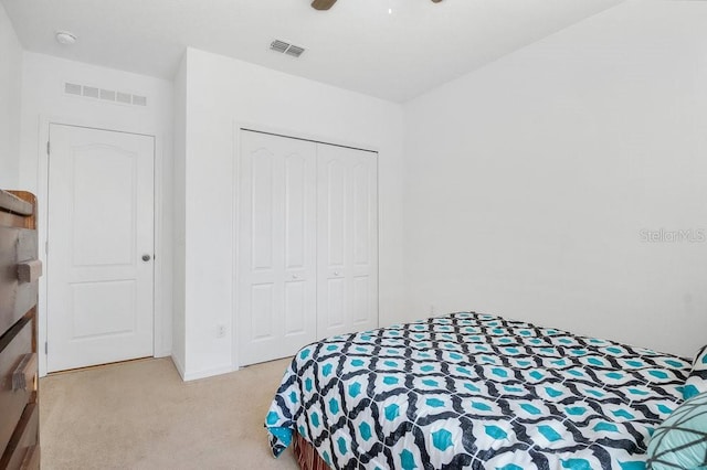 bedroom featuring a closet, ceiling fan, and light colored carpet