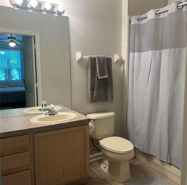 bathroom featuring vanity, toilet, tile patterned flooring, and a shower with shower curtain