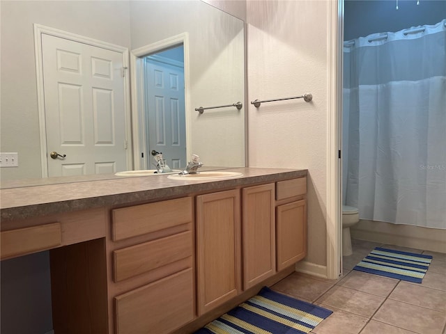 bathroom featuring vanity, a shower with shower curtain, toilet, and tile patterned floors