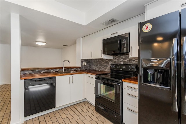 kitchen with black appliances, sink, backsplash, white cabinetry, and wooden counters