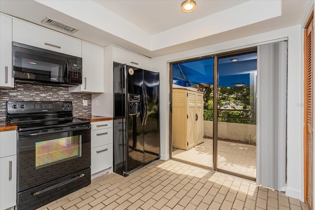 kitchen featuring decorative backsplash, white cabinetry, and black appliances