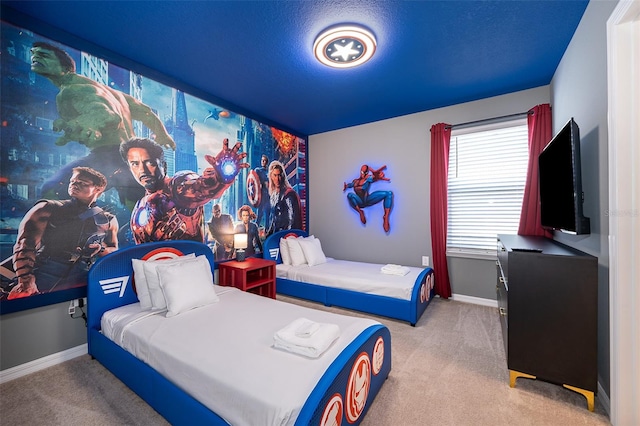 bedroom with light carpet and a textured ceiling