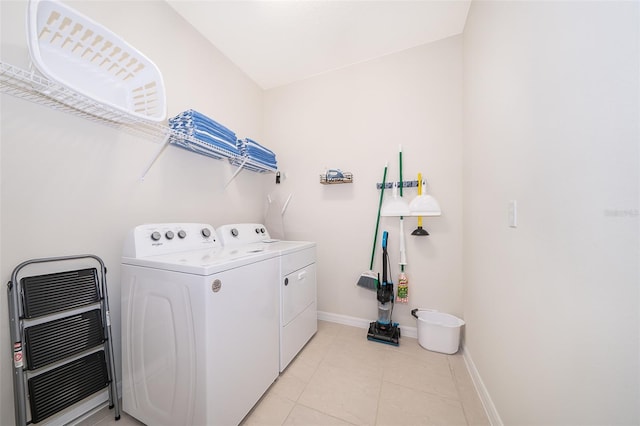 laundry room featuring heating unit, separate washer and dryer, and light tile patterned floors