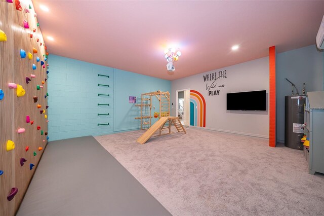 recreation room with light carpet and electric water heater