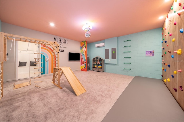 playroom featuring carpet floors, electric panel, and an AC wall unit