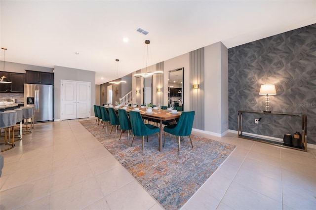 dining space featuring light tile patterned floors