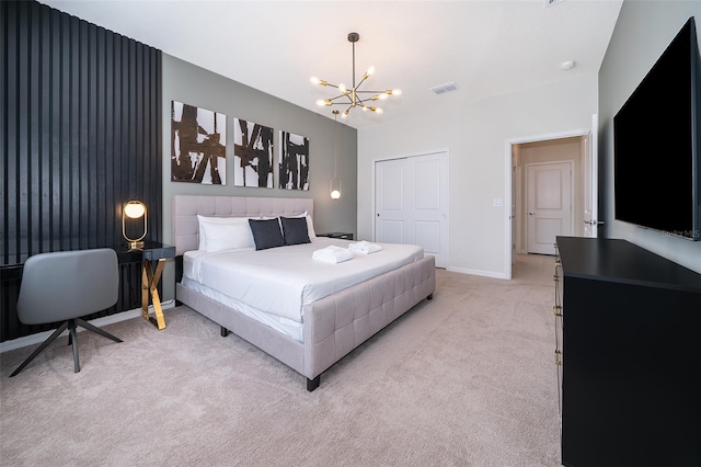 carpeted bedroom featuring a notable chandelier and a closet