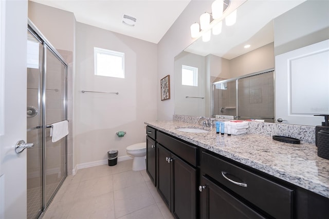 bathroom featuring vanity, toilet, a wealth of natural light, and an enclosed shower