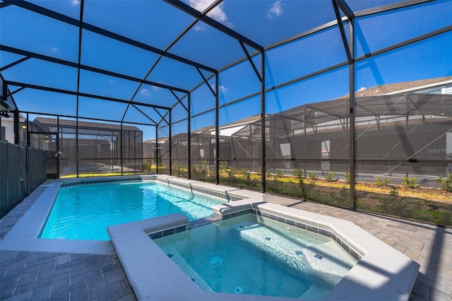 view of swimming pool with a patio, an in ground hot tub, and glass enclosure