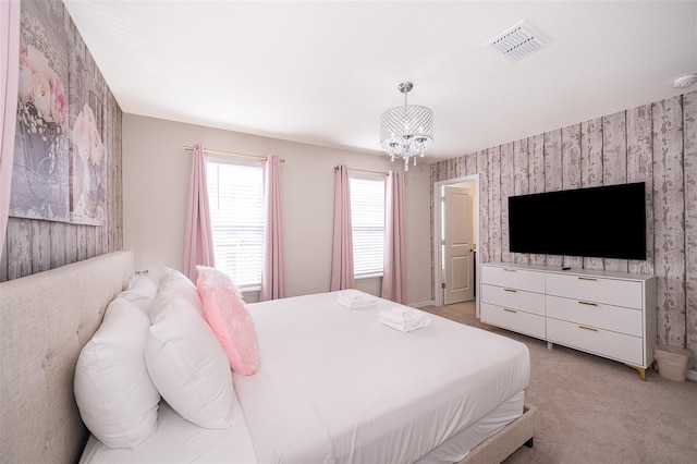 bedroom with an inviting chandelier and light colored carpet