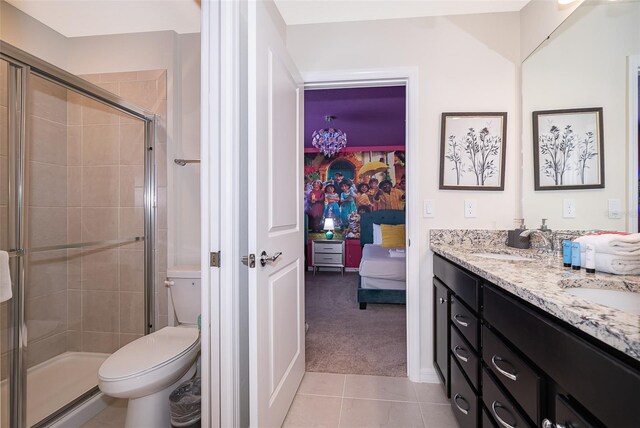 bathroom featuring vanity, tile patterned flooring, toilet, and walk in shower