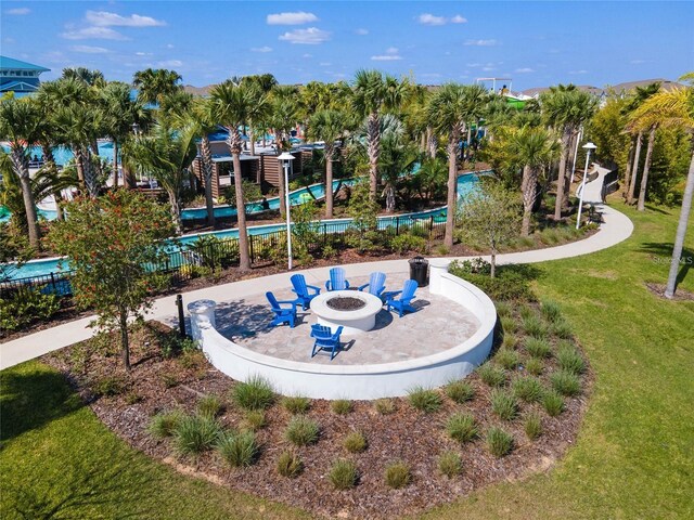 view of community featuring a fire pit and a yard