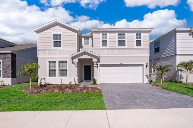 view of front of house featuring a front yard and a garage