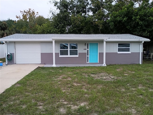 single story home featuring a front yard and a garage