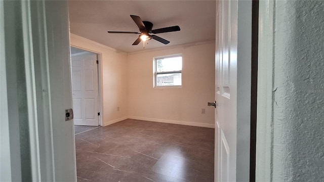 empty room with ceiling fan and ornamental molding