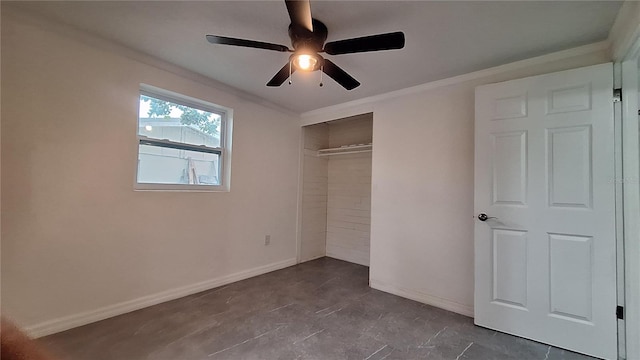 unfurnished bedroom featuring ceiling fan, a closet, and crown molding