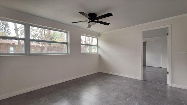 empty room featuring ceiling fan and crown molding