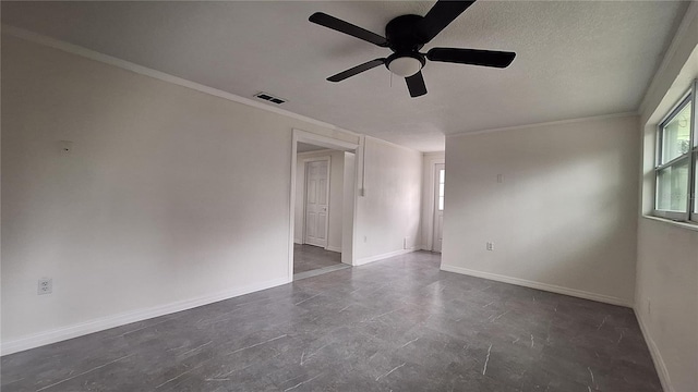 spare room featuring ceiling fan and ornamental molding