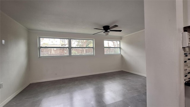 empty room with ceiling fan and crown molding