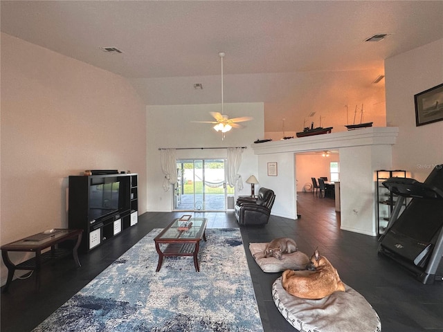 living room featuring ceiling fan, lofted ceiling, and dark hardwood / wood-style floors