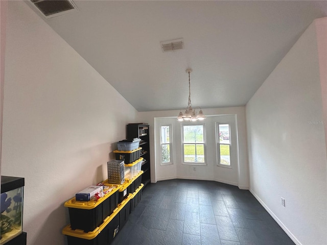 interior space with a chandelier and vaulted ceiling