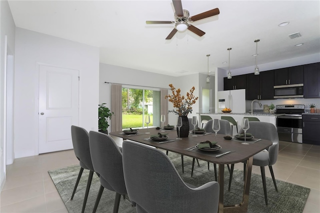 tiled dining room featuring ceiling fan