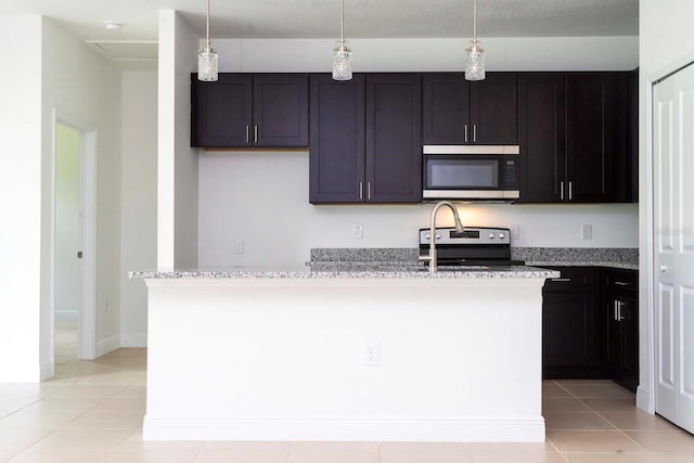 kitchen featuring light stone countertops, appliances with stainless steel finishes, light tile patterned floors, and pendant lighting