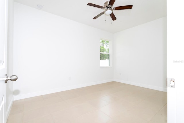 empty room with ceiling fan and light tile patterned flooring