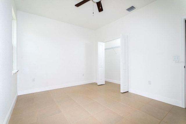 tiled spare room featuring ceiling fan