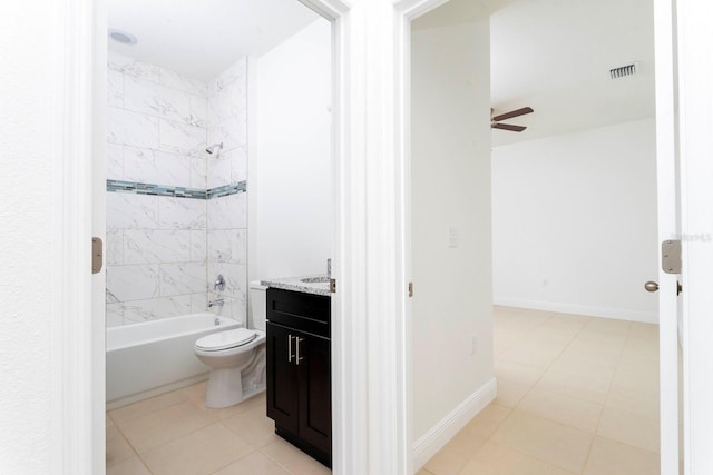 full bathroom with vanity, tiled shower / bath combo, toilet, and tile patterned flooring