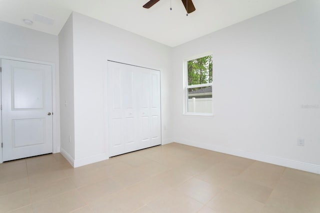 unfurnished bedroom featuring a closet, ceiling fan, and light tile patterned floors