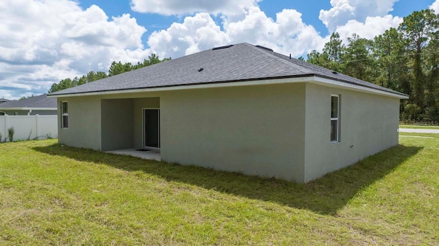 rear view of house featuring a yard