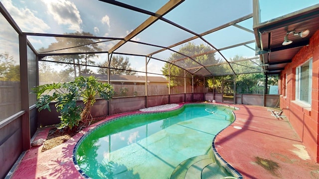 view of swimming pool with a patio and glass enclosure